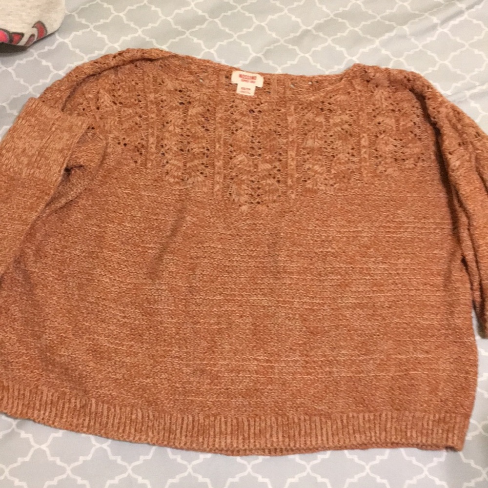 This is a tan sweater.